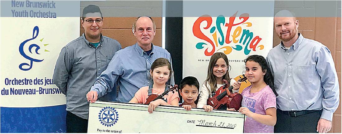 Pictured is (left to right) Carlos Armao, the Sistema NB centre director; Don Matheson, chief operating officer of NBYO; and Newcastle Rotarian Matt Doherty along with just some of the children that take part in this wonderful program. PHOTO: SUBMITTED